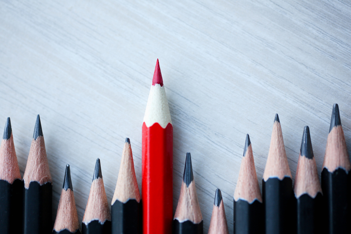 Red pencil standing out from crowd of